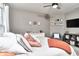 Bright bedroom with a ceiling fan, soft rug, large TV, and warm accents at 11233 Rockingham Cir, Fishers, IN 46037