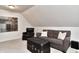 A bonus room with couch, coffee table and decorations provides comfortable gathering space at 11233 Rockingham Cir, Fishers, IN 46037