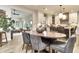 Open-concept dining area flows into kitchen, featuring hardwood floors, stylish furnishings, and lots of natural light at 11233 Rockingham Cir, Fishers, IN 46037