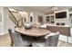 Spacious dining area showcases hardwood floors, large dining table and an open concept connection to the living room at 11233 Rockingham Cir, Fishers, IN 46037
