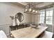 Elegant dining room with modern light fixture, decor, and natural light from the large window at 11233 Rockingham Cir, Fishers, IN 46037