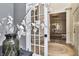 Entryway with hardwood floors, a round rug, and French doors leading to a dining room at 11233 Rockingham Cir, Fishers, IN 46037