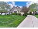 Lovely home with a well-maintained lawn, mature trees, and a long driveway leading to the garage at 11233 Rockingham Cir, Fishers, IN 46037