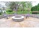 Cozy backyard fire pit surrounded by comfortable chairs and a stone seating wall for outdoor gatherings at 11233 Rockingham Cir, Fishers, IN 46037
