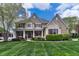Charming two-story home featuring a manicured lawn, stone accents, and inviting front porch at 11233 Rockingham Cir, Fishers, IN 46037