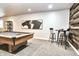 Basement game room with a pool table, high-top table and chairs and modern decor at 11233 Rockingham Cir, Fishers, IN 46037
