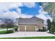 Spacious three-car garage with a basketball hoop, adjacent to a beautifully landscaped yard at 11233 Rockingham Cir, Fishers, IN 46037