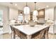 Well-equipped kitchen features a central island, modern light fixtures, and quartz counters with tile backsplash at 11233 Rockingham Cir, Fishers, IN 46037