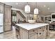 Bright, open kitchen offers island with seating, modern appliances, hardwood floors and easy access to main living area at 11233 Rockingham Cir, Fishers, IN 46037