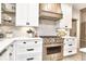 Well-appointed kitchen features white cabinetry, stainless steel appliances, tile backsplash, and wood accents at 11233 Rockingham Cir, Fishers, IN 46037