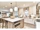 Spacious open kitchen boasts an island with seating, modern appliances, stylish lighting, and easy access to other living areas at 11233 Rockingham Cir, Fishers, IN 46037