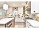 Modern kitchen features quartz counters, stainless steel appliances, tile backsplash, and light wood flooring at 11233 Rockingham Cir, Fishers, IN 46037