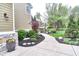 Lush garden pathway featuring vibrant flowers and neatly trimmed shrubs leading through a landscaped yard at 11233 Rockingham Cir, Fishers, IN 46037