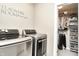 Convenient laundry area with updated machines and space-saving shelving at 11233 Rockingham Cir, Fishers, IN 46037