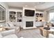 Cozy living room featuring a fireplace, built-in bookshelves, and comfortable seating at 11233 Rockingham Cir, Fishers, IN 46037