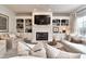 Spacious living room with a fireplace, built-in bookshelves, and comfortable seating at 11233 Rockingham Cir, Fishers, IN 46037