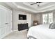 Bright bedroom with a ceiling fan, large windows, mounted TV, and a cozy reading nook at 11233 Rockingham Cir, Fishers, IN 46037
