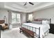 Spacious bedroom with natural light, a ceiling fan, and a stylish upholstered bench at 11233 Rockingham Cir, Fishers, IN 46037