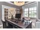 Home office with a view, featuring a large desk, and modern décor at 11233 Rockingham Cir, Fishers, IN 46037