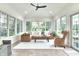 Bright sunroom with ample windows, vaulted ceilings, neutral furnishings, and access to outdoor living space at 11233 Rockingham Cir, Fishers, IN 46037