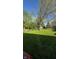 A spacious backyard with well-maintained lawn and surrounding trees, perfect for outdoor activities at 1205 N Gibson Ave, Indianapolis, IN 46219