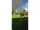 Expansive backyard view with a barn, mature tree, and plenty of green space at 1205 N Gibson Ave, Indianapolis, IN 46219
