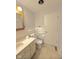 Standard bathroom with a white toilet, sink, and door at 1205 N Gibson Ave, Indianapolis, IN 46219