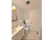 Standard bathroom with a white toilet, sink, and door at 1205 N Gibson Ave, Indianapolis, IN 46219