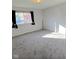 The empty bedroom has carpet floors and is naturally lit at 1205 N Gibson Ave, Indianapolis, IN 46219
