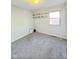 An empty bedroom with carpet flooring and plenty of light at 1205 N Gibson Ave, Indianapolis, IN 46219