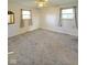 Large, carpeted bedroom with neutral walls, natural light from two windows, and ceiling fan at 1205 N Gibson Ave, Indianapolis, IN 46219