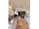 The kitchen showcases white cabinets, hardwood floors and a view into the living room at 1205 N Gibson Ave, Indianapolis, IN 46219