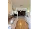 The kitchen showcases white cabinets, hardwood floors and a view into the living room at 1205 N Gibson Ave, Indianapolis, IN 46219