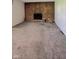 A brick fireplace creates a focal point for this living room with neutral walls and flooring at 1205 N Gibson Ave, Indianapolis, IN 46219