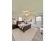 This staged main bedroom is enhanced by the natural light, soft colors, and fan at 1205 N Gibson Ave, Indianapolis, IN 46219
