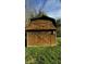 The property includes a wooden barn with x-shaped doors, offering ample storage at 1205 N Gibson Ave, Indianapolis, IN 46219