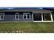 Backyard view of the dark blue siding, white framed windows and covered patio area, perfect for outdoor gatherings at 1221 Malbec Cir, Westfield, IN 46074