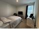 Cozy bedroom featuring comfortable bed, work space, and natural light from the large window at 1221 Malbec Cir, Westfield, IN 46074