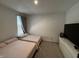 Bright bedroom with two twin beds and a modern dresser for ample storage space at 1221 Malbec Cir, Westfield, IN 46074