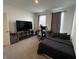 Bedroom boasts a large TV, a gaming setup, and comfortable, neutral tones throughout at 1221 Malbec Cir, Westfield, IN 46074