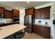 Modern kitchen featuring stainless steel appliances, a large island, and dark wood cabinets at 1221 Malbec Cir, Westfield, IN 46074
