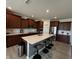 Spacious kitchen with stainless steel appliances, generous counter space, and seating at the large center island at 1221 Malbec Cir, Westfield, IN 46074