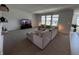 Spacious living room featuring a neutral-toned sectional couch with large windows for natural light at 1221 Malbec Cir, Westfield, IN 46074