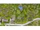 Beautiful aerial shot of property, surrounded by woods and a community basketball court at 13 Ridgeline Dr, Brownsburg, IN 46112
