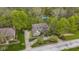 Aerial view of a home with a spacious driveway and lush landscaping, backing up to a natural tree preserve at 13 Ridgeline Dr, Brownsburg, IN 46112