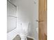 Clean white bathroom featuring a toilet, a glass enclosed shower, and a natural wood door at 13 Ridgeline Dr, Brownsburg, IN 46112