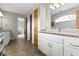 Bathroom featuring granite countertops, white cabinetry, and tile flooring, plus decorative mirrors at 13 Ridgeline Dr, Brownsburg, IN 46112