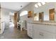 Spacious bathroom with granite countertops, white cabinetry, and a unique arched window at 13 Ridgeline Dr, Brownsburg, IN 46112