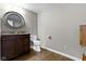 Powder room with stylish vanity, decorative mirror, and hardwood flooring at 13 Ridgeline Dr, Brownsburg, IN 46112