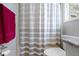 Bathroom with shower and tub combo, toilet, vanity, and decorative neutral-striped shower curtain at 13 Ridgeline Dr, Brownsburg, IN 46112